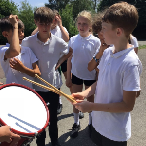 Millbrook Primary School Pupil trying drums