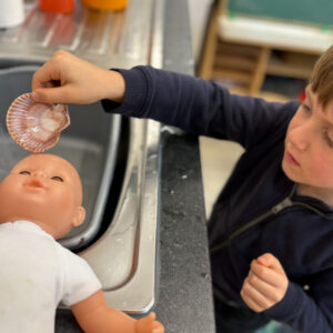 St Dominic Primary Pupil baptising doll St Dominic Primary Pupil baptising doll