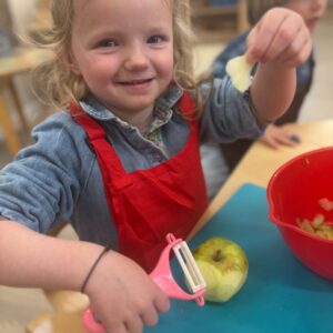St Dominic Primary Pupil peeling apples
