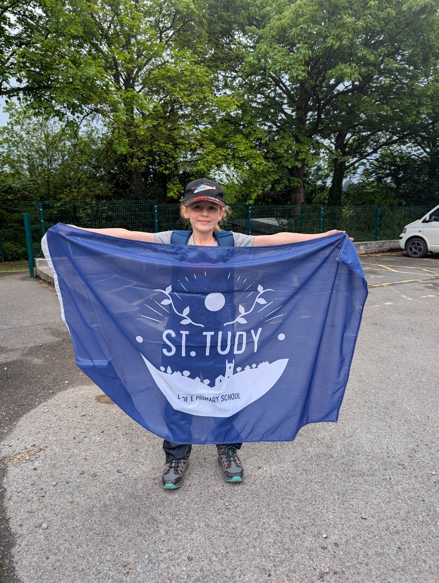 St Tudy Primary School Pupil displaying school flag