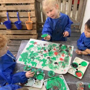 St Winnow Primary School Pupils painting outdoors