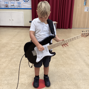 Cygnets Nursery St Germans Pupil playing guitar