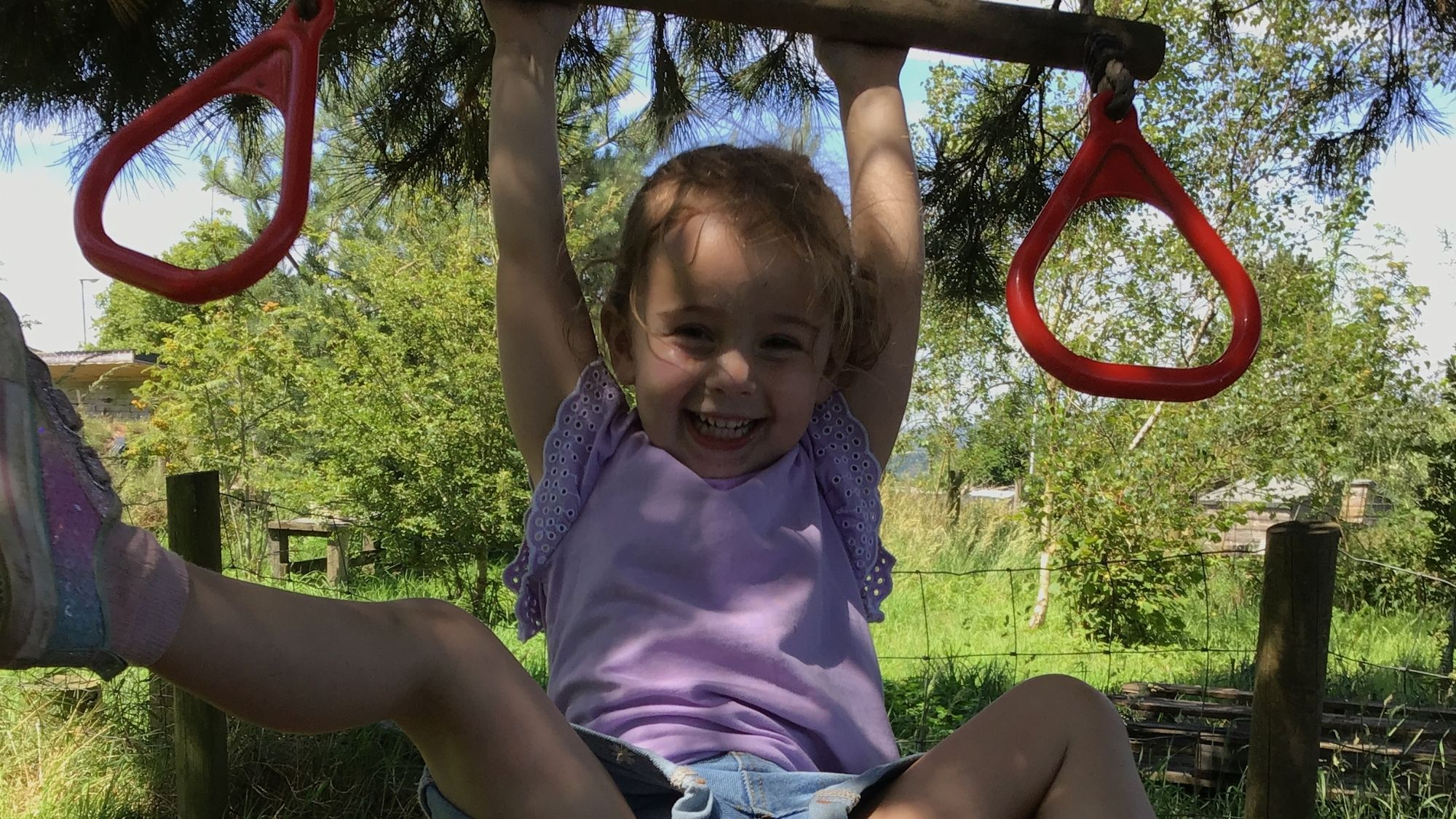 Acorns Nursery Child playing on trapeze