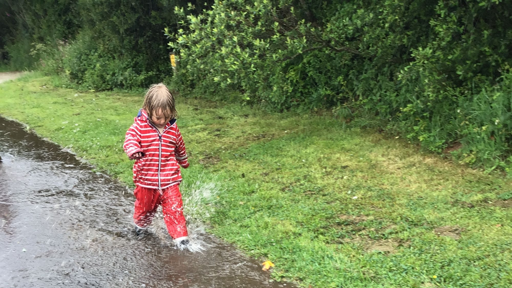 Acorns Nursery Child splashing in puddle Acorns Nursery Child splashing in puddle