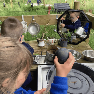 Burrows Nursery child playing with outdoor kitchen