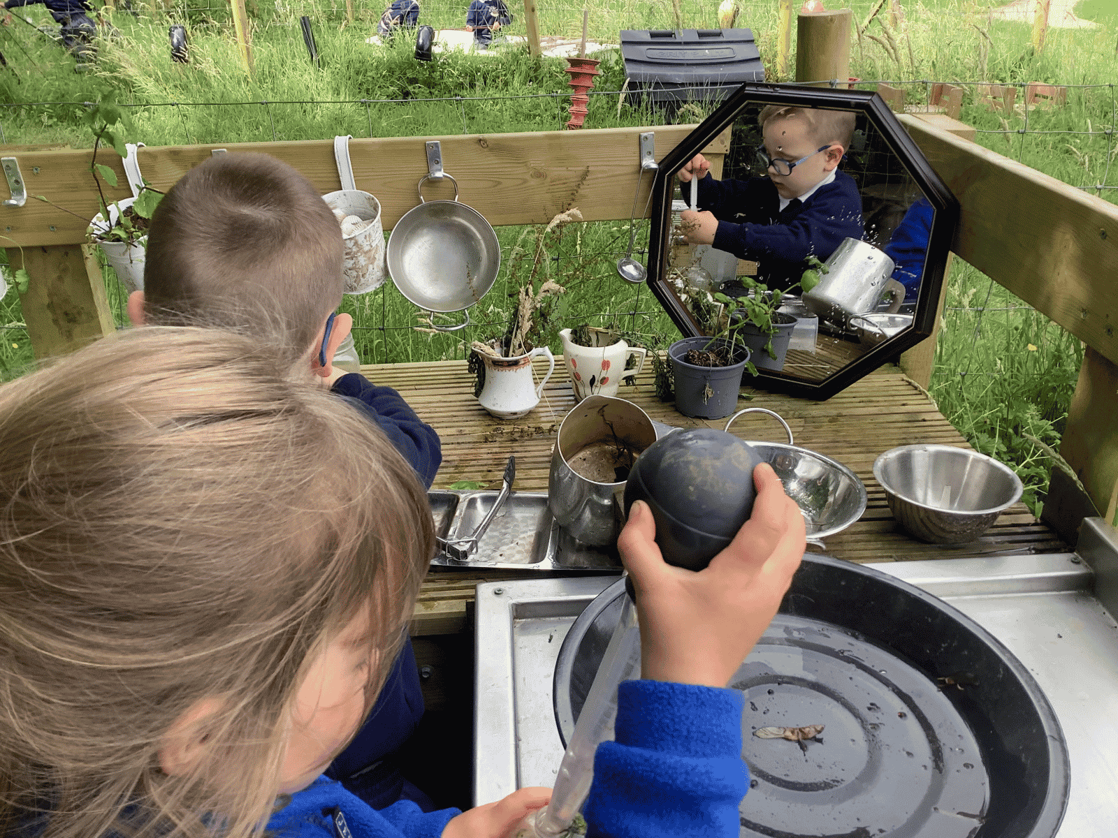 Burrows Nursery child playing with outdoor kitchen