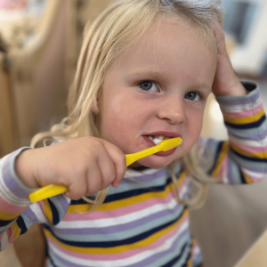 St Dominic Nursery School Pupil brushing teeth